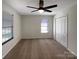 A bright bedroom featuring plush carpet, neutral walls, ceiling fan and closet at 205 Mauney St, Mount Holly, NC 28120