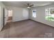A naturally lit bedroom featuring plush carpet, neutral walls and a view of the outdoors at 205 Mauney St, Mount Holly, NC 28120