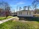 One-story home featuring a well-maintained lawn and a concrete walkway leading to the front entrance at 205 Mauney St, Mount Holly, NC 28120
