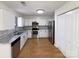 Updated kitchen featuring stainless steel appliances, white cabinets, granite countertops and hardwood floors at 205 Mauney St, Mount Holly, NC 28120