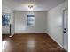 A naturally lit living room featuring hardwood floors, neutral walls and a bright window at 205 Mauney St, Mount Holly, NC 28120