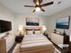 Staged primary bedroom features calming decor, with a large ceiling fan, dressers, and hardwood floors at 205 Mauney St, Mount Holly, NC 28120