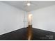 Empty bedroom featuring a ceiling fan, dark wood floors, and a double door closet at 2286 Kilborne Dr, Charlotte, NC 28205
