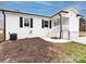 Charming home featuring a white brick exterior, black shutters, and a welcoming front entrance with white railings at 2286 Kilborne Dr, Charlotte, NC 28205