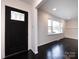 Inviting foyer with elegant dark hardwood floors, a black front door with decorative glass, and natural light at 2286 Kilborne Dr, Charlotte, NC 28205