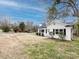 Exterior view of a quaint home with a white exterior, black shutters, and a well-maintained lawn at 2286 Kilborne Dr, Charlotte, NC 28205