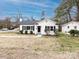 A charming white home with black shutters and a neatly landscaped yard creates a welcoming curb appeal at 2286 Kilborne Dr, Charlotte, NC 28205