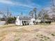The side angle showcases the home's clean white facade, complemented by black shutters and a spacious yard at 2286 Kilborne Dr, Charlotte, NC 28205