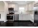 This is a beautiful kitchen featuring white cabinetry and stainless steel appliances at 2286 Kilborne Dr, Charlotte, NC 28205