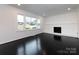 Bright living room with dark hardwood floors, fresh neutral paint and a large window with outdoor views at 2286 Kilborne Dr, Charlotte, NC 28205