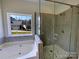 Bathroom featuring a soaking tub, a glass-enclosed shower, and mosaic tile accents at 235 Glenville Dr, Fort Mill, SC 29715