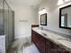 Elegant bathroom with dual sinks, granite countertops, and a glass-enclosed shower at 235 Glenville Dr, Fort Mill, SC 29715