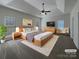 Tranquil main bedroom with tray ceilings, a ceiling fan, and a cozy seating area at 235 Glenville Dr, Fort Mill, SC 29715