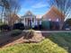 Charming brick home with a welcoming front porch and well-manicured landscaping at 235 Glenville Dr, Fort Mill, SC 29715