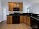 Well-appointed kitchen featuring black appliances, granite countertops, and ample cabinet space at 235 Glenville Dr, Fort Mill, SC 29715