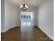 Open living space featuring tile flooring, chandelier, and bright natural light at 235 Glenville Dr, Fort Mill, SC 29715
