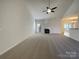 Spacious living room featuring a fireplace, neutral carpet and a view into the dining area at 235 Glenville Dr, Fort Mill, SC 29715