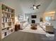 Bright living room showcasing a fireplace, vaulted ceiling, and stylish furnishings at 235 Glenville Dr, Fort Mill, SC 29715