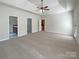 Spacious main bedroom with neutral carpet, ceiling fan, and en-suite bathroom at 235 Glenville Dr, Fort Mill, SC 29715