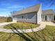 Rear exterior view featuring a side-entry garage, patio, and landscaped yard at 235 Glenville Dr, Fort Mill, SC 29715