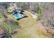 An aerial view of a home with a pool, a shed, a patio, and a huge lawn on a sunny day at 2659 Surrey Dr, Lincolnton, NC 28092