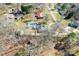 Aerial view of a home with an in-ground pool, shed, long driveway, and spacious, partially wooded yard at 2659 Surrey Dr, Lincolnton, NC 28092