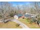 An overhead view shows the property's well-manicured lawn and beautiful landscaping with a two-car garage and red front door at 2659 Surrey Dr, Lincolnton, NC 28092