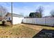 A gated, white fence leads to a utility building with a walkway and a yard with sparse grass at 2659 Surrey Dr, Lincolnton, NC 28092