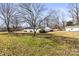 A spacious, open backyard featuring lush greenery, a privacy fence, and mature trees, offering ample space at 2659 Surrey Dr, Lincolnton, NC 28092