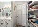 Bright bathroom featuring a sleek white vanity, well-lit mirror, and convenient built-in towel storage for an organized space at 2659 Surrey Dr, Lincolnton, NC 28092