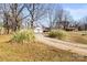 A long driveway leads to a charming home with a well-maintained lawn and mature trees at 2659 Surrey Dr, Lincolnton, NC 28092