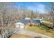 Aerial view of brick home with a two car garage, well maintained yard, and an in ground pool at 2659 Surrey Dr, Lincolnton, NC 28092