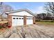Spacious two-car garage, offering ample parking and storage space, complemented by a brick exterior and well-maintained driveway at 2659 Surrey Dr, Lincolnton, NC 28092