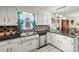 Traditional kitchen with black countertops, white cabinets, tiled backsplash and stainless steel dishwasher at 2659 Surrey Dr, Lincolnton, NC 28092