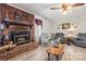 Cozy living room featuring a decorative fireplace, hardwood floors, and comfortable furniture at 2659 Surrey Dr, Lincolnton, NC 28092