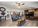 Open living room with hardwood floors, ceiling fan and a large gray sofa at 2659 Surrey Dr, Lincolnton, NC 28092