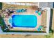 Aerial view of a fenced in backyard pool with chairs and tables surrounding the area, perfect for outdoor relaxation at 2659 Surrey Dr, Lincolnton, NC 28092