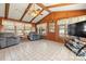 Bright sunroom featuring wood paneled walls and ceiling, tile floors, and cozy seating area at 2659 Surrey Dr, Lincolnton, NC 28092