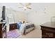 Bright bedroom featuring a ceiling fan, white iron bed frame, and two dressers at 2988 Clover Nw Rd, Concord, NC 28027