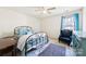 Serene bedroom featuring a ceiling fan, area rug, and teal accent chair at 2988 Clover Nw Rd, Concord, NC 28027
