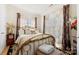 Sunlit bedroom featuring a gold metal bed frame, decorative curtains, and neutral décor at 2988 Clover Nw Rd, Concord, NC 28027