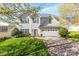 Charming two-story home with green shutters, blooming trees, a well-manicured lawn and a two-car garage at 2988 Clover Nw Rd, Concord, NC 28027
