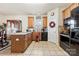 Eat-in kitchen with granite countertops, tile flooring, and wood cabinetry at 2988 Clover Nw Rd, Concord, NC 28027