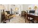 Sitting room boasts two armchairs, a computer desk, and a staircase leading to the upper level of the home at 2988 Clover Nw Rd, Concord, NC 28027