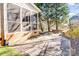 Exterior of home showing backyard patio, screened in porch, landscaping and retaining wall at 305 Chancelot Ln, Fort Mill, SC 29708