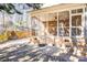 Exterior view of the brick home, showcasing a screened in porch, and beautiful patio area at 305 Chancelot Ln, Fort Mill, SC 29708