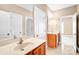 Bright bathroom featuring double sinks with wood cabinets and large mirrors at 305 Chancelot Ln, Fort Mill, SC 29708