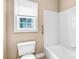Clean bathroom featuring a toilet, bathtub and window letting in natural light at 305 Chancelot Ln, Fort Mill, SC 29708