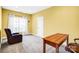 Inviting bedroom with warm yellow walls, a cozy chair, and a wooden desk at 305 Chancelot Ln, Fort Mill, SC 29708