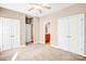 Spacious bedroom featuring neutral tones, plush carpeting, a ceiling fan and double door closets at 305 Chancelot Ln, Fort Mill, SC 29708